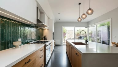 Modern kitchen interior with green tiles and islands